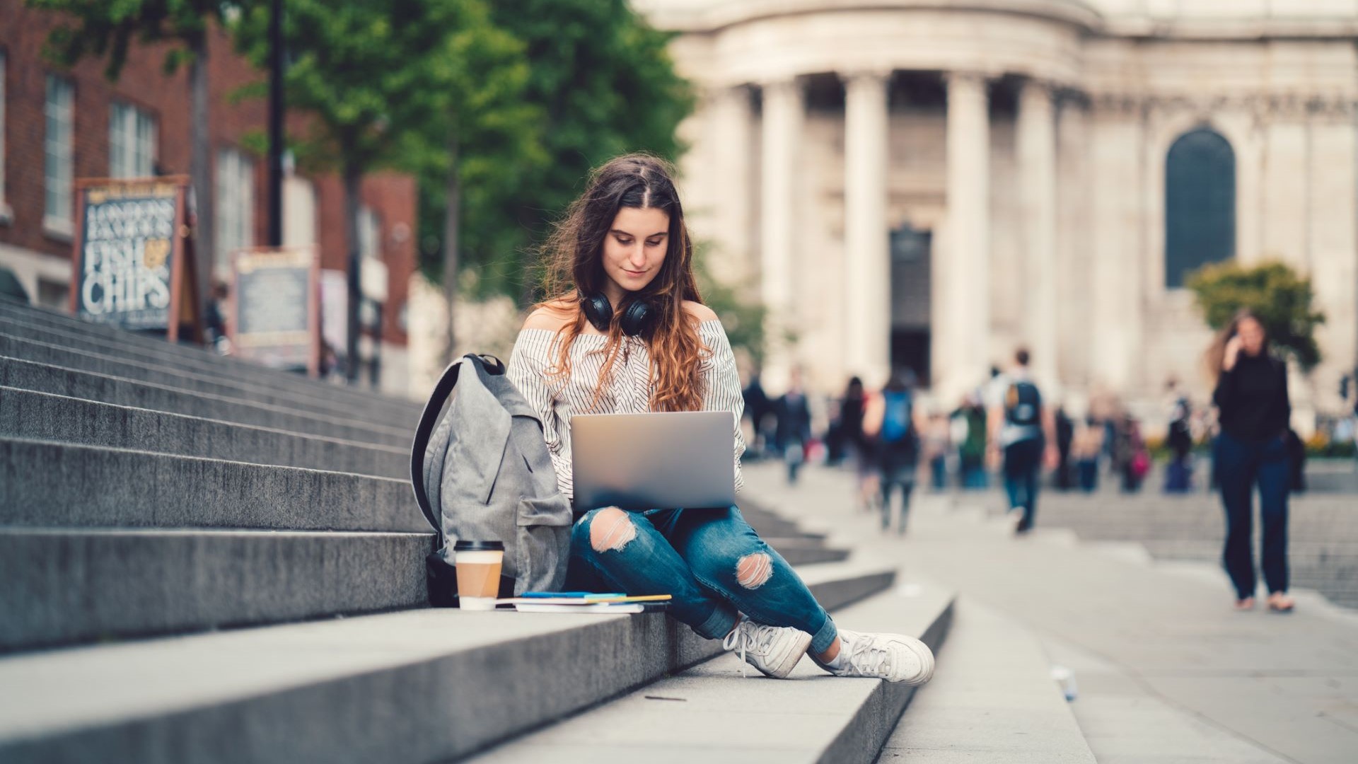 student sitting on steps studying
