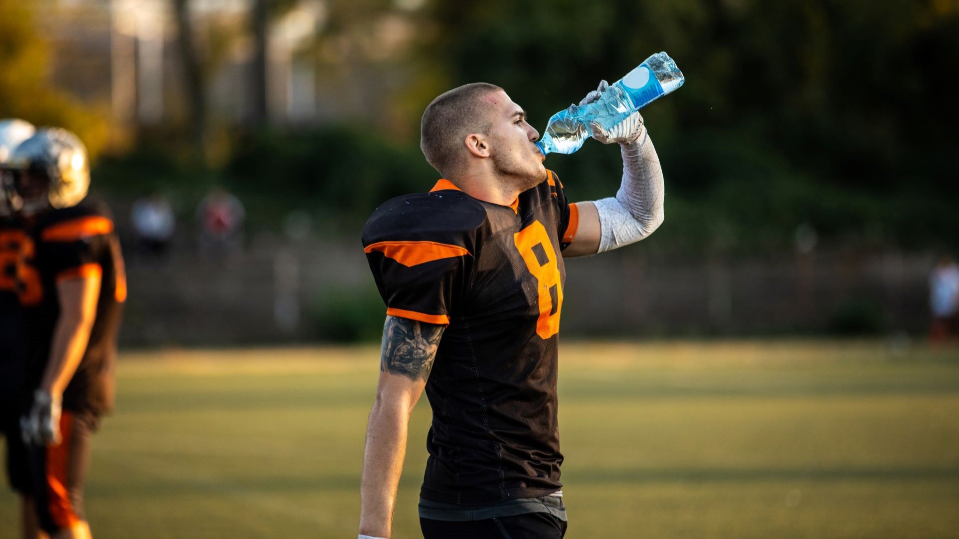 football player drinking water